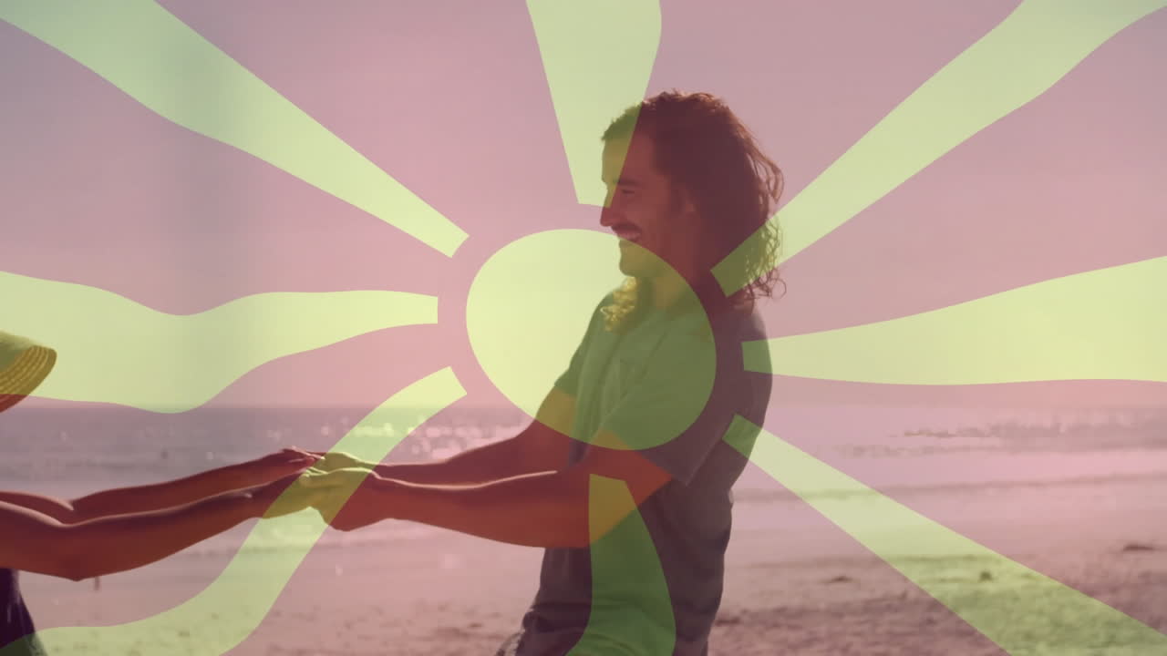 Holding hands on beach, people with sunburst animation overlay, enjoying sunset