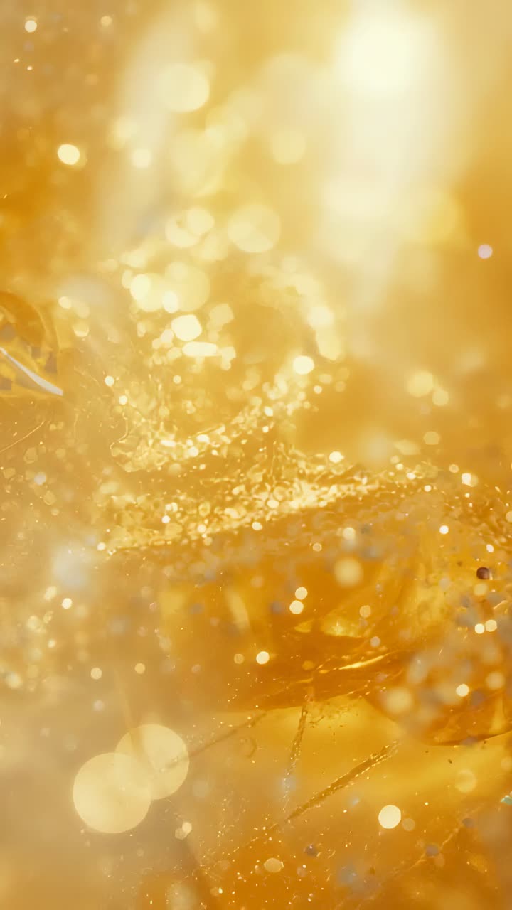 Vertical video: Pulling focus, camera revealing thick gold resin studio macro showing glitter beads