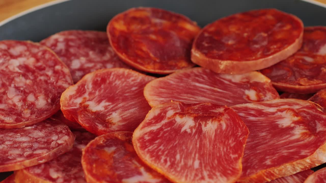 Mix of spanish pork sausages, Cutting board of appetizing catalonian snack - fuet, jamon, chorizo, olives, supermarket tapas food in spain, traditional cuisine.