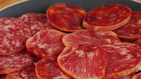 mix of spanish pork sausages, cutting board of appetizing catalonian snack - fuet, jamon, chorizo, olives, supermarket tapas food in spain, traditional cuisine.