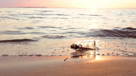 message in the bottle against the sun setting down