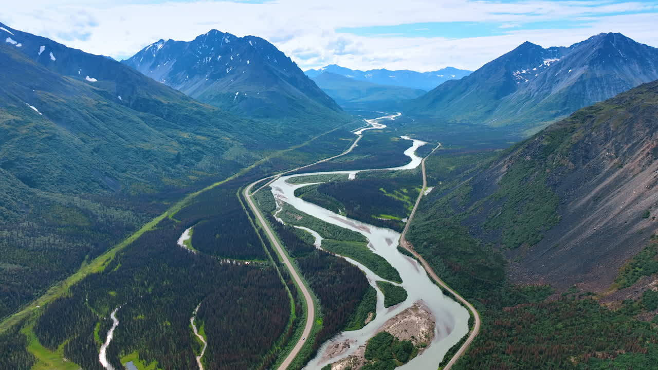 Valley river winding through Alaska. Scenic Alaskan valley with a winding river between rugged green mountains