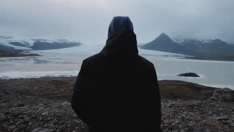 person gazing at glacier landscape