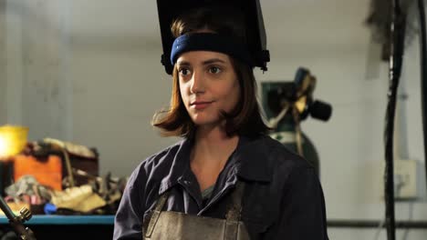 female welder holding welding torch