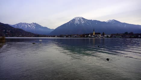 background view of snow capped mountains and a church in the alps