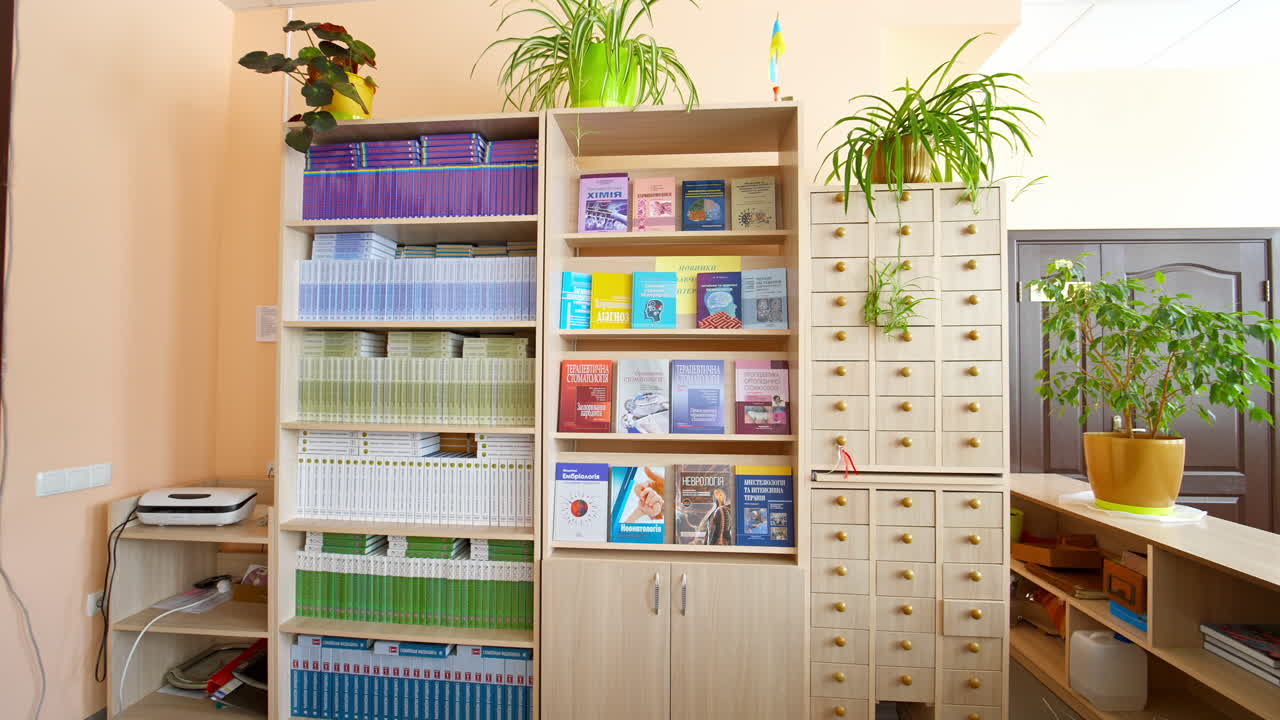 Books on bookshelf in library. Interior of the library with shelves full of books