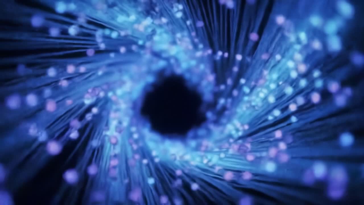 A mesmerizing spiral of luminous particles in deep blue and purple hues, creating a dynamic illusion of depth and motion within a dark vortex-like space.