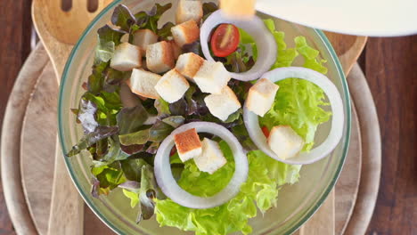 top view on adding dry breadcrumbs to the salad bowl