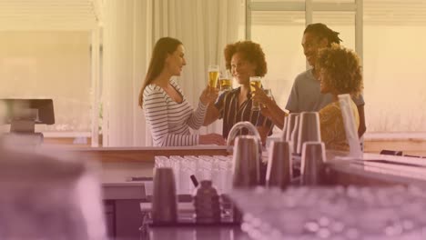 animation of beer icons over happy diverse friends talking and drinking beer