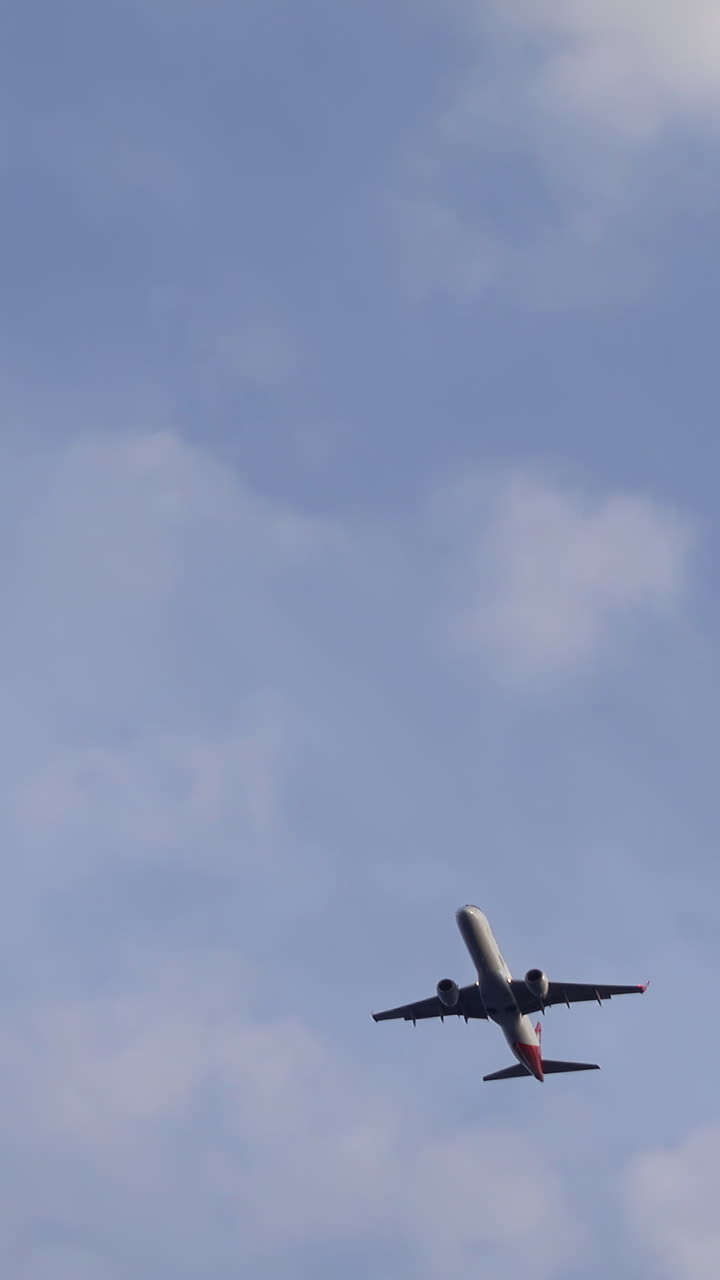 Airplane flying in the cloudy sky. Vertical, Cannes, France