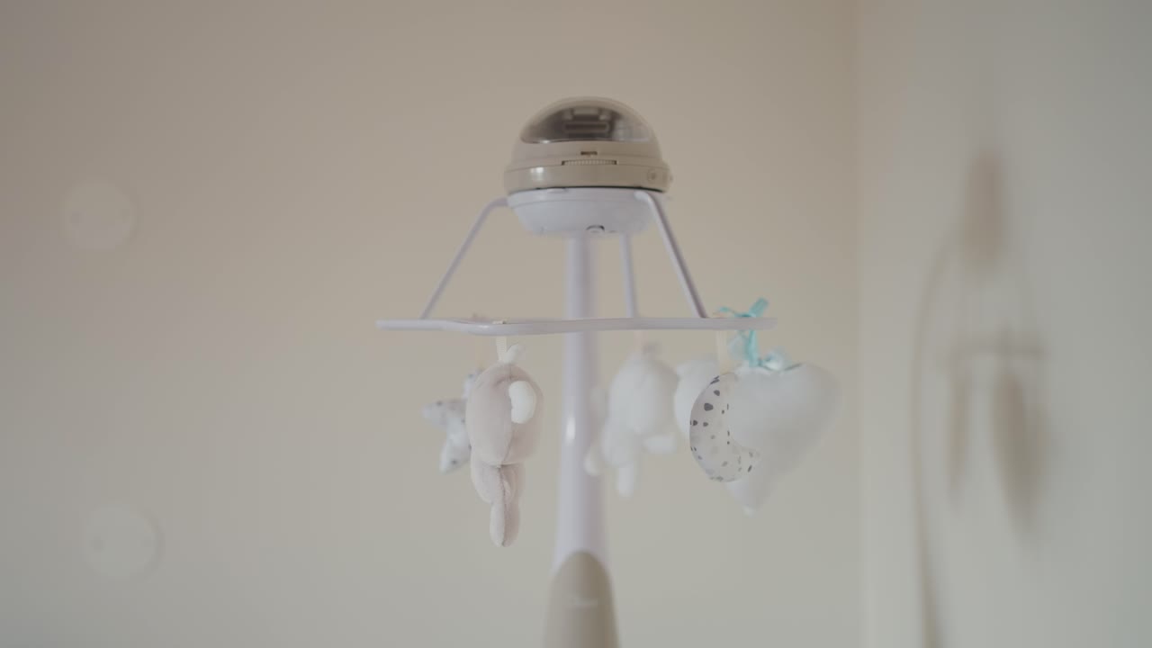 Gentle nursery mobile with hanging soft toys and soothing neutral tones