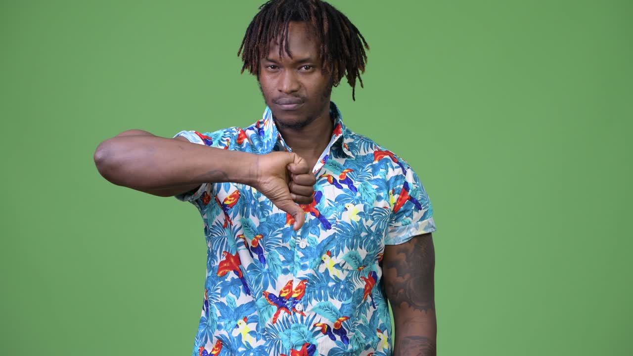 Young handsome African tourist man giving thumbs down