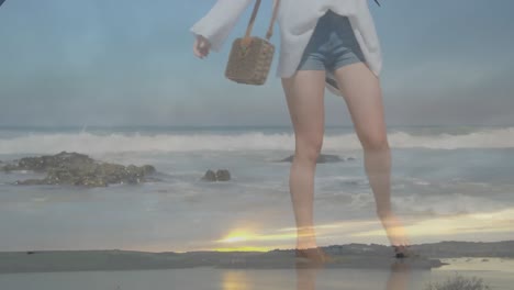 Animation-of-caucasian-woman-walking-on-beach-by-sea-over-landscape