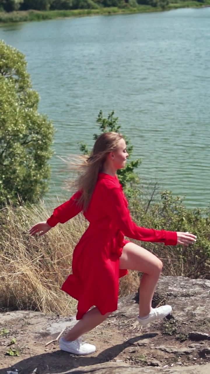 Carefree young woman on nature. View of free woman enjoying life on nature. Vertical video