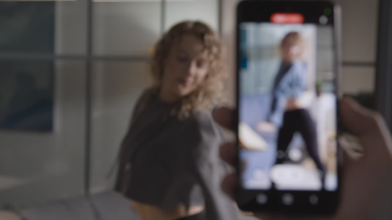 Person Recording Social Media Video On Mobile Phone Of Woman Dancing At Home 1