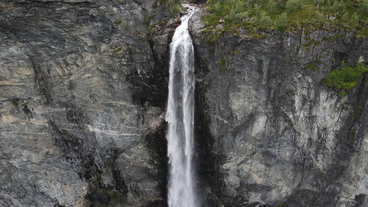 Zoomning out slow drone footage of Vettisfosesen waterfall in Norway
