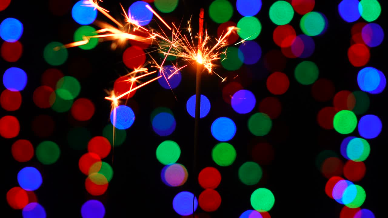A close-up macro shot of one burning New Year sparkler.