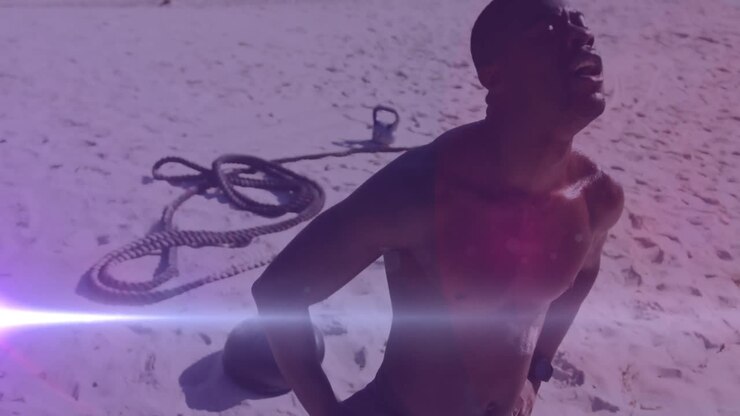 Animation of glowing lights over an exercising african american man