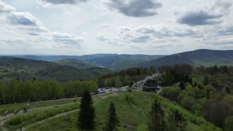 beautiful mountain landscape during a summer day with mountains peaks, forest, lush greenery and trees