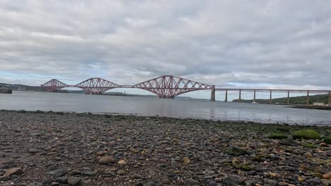 iconic bridge spans across calm scottish waters