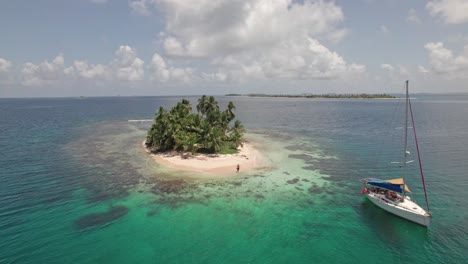 drone clip in san blas islands (panama) with a sailboat anchored in a remote island.