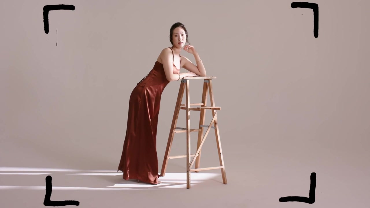 Model leaning on ladder, marks overlaying frames moving causing turning and adjusting for fashion