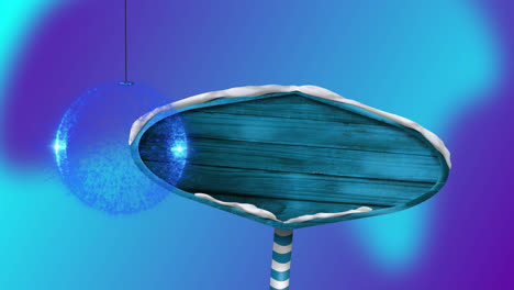 blue bauble decoration hanging over blue wooden sign board against blue gradient background