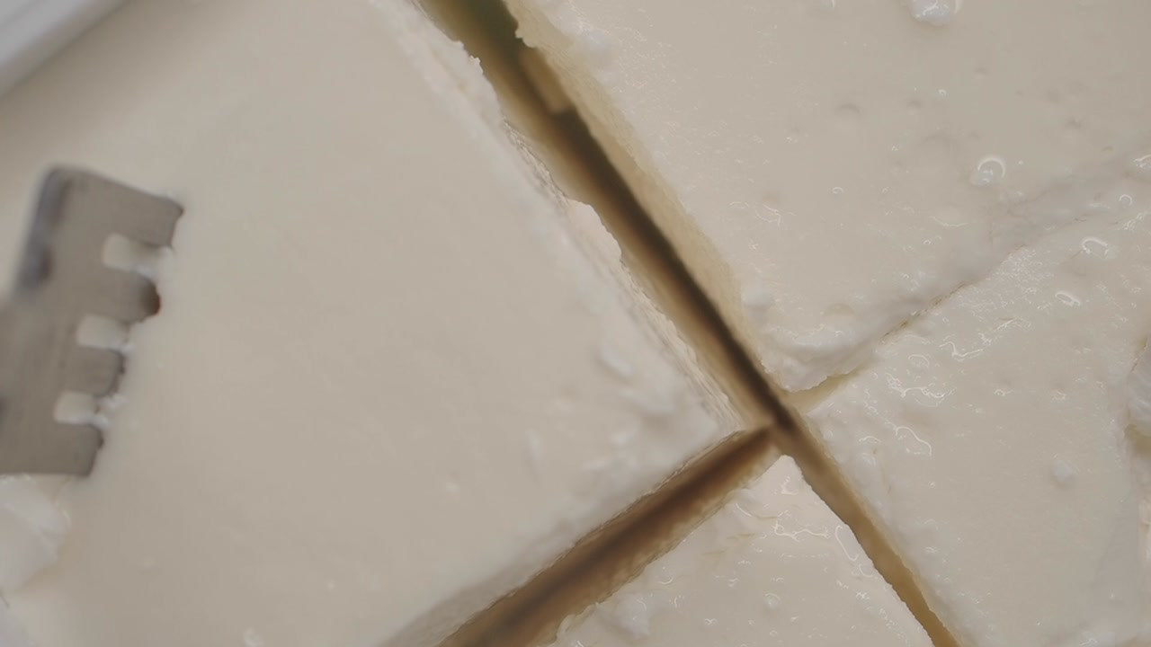 Close-up of Feta Cheese Blocks in Brine with Fork