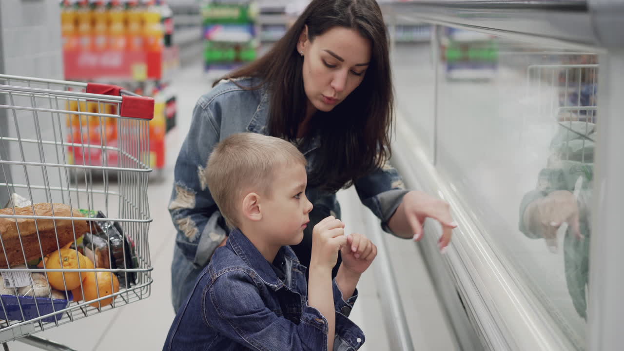 Mother and son shopping for groceries
