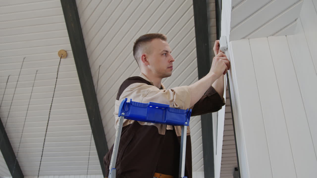 Handyman Installing Device or Sensor in House