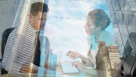 animation of caucasian businessman and businesswoman discussing over office buildings and clouds