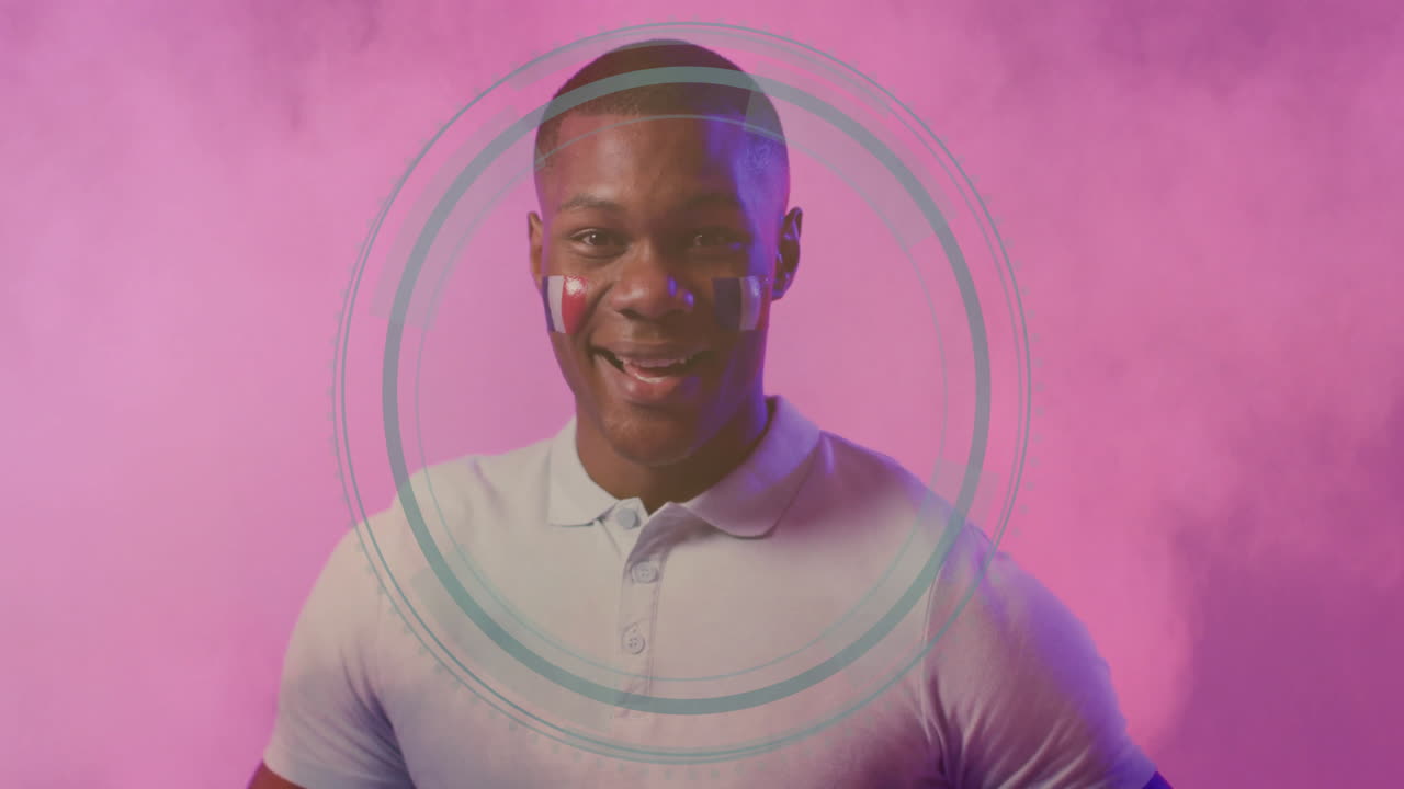 Man with face paint and circular animation design on pink background
