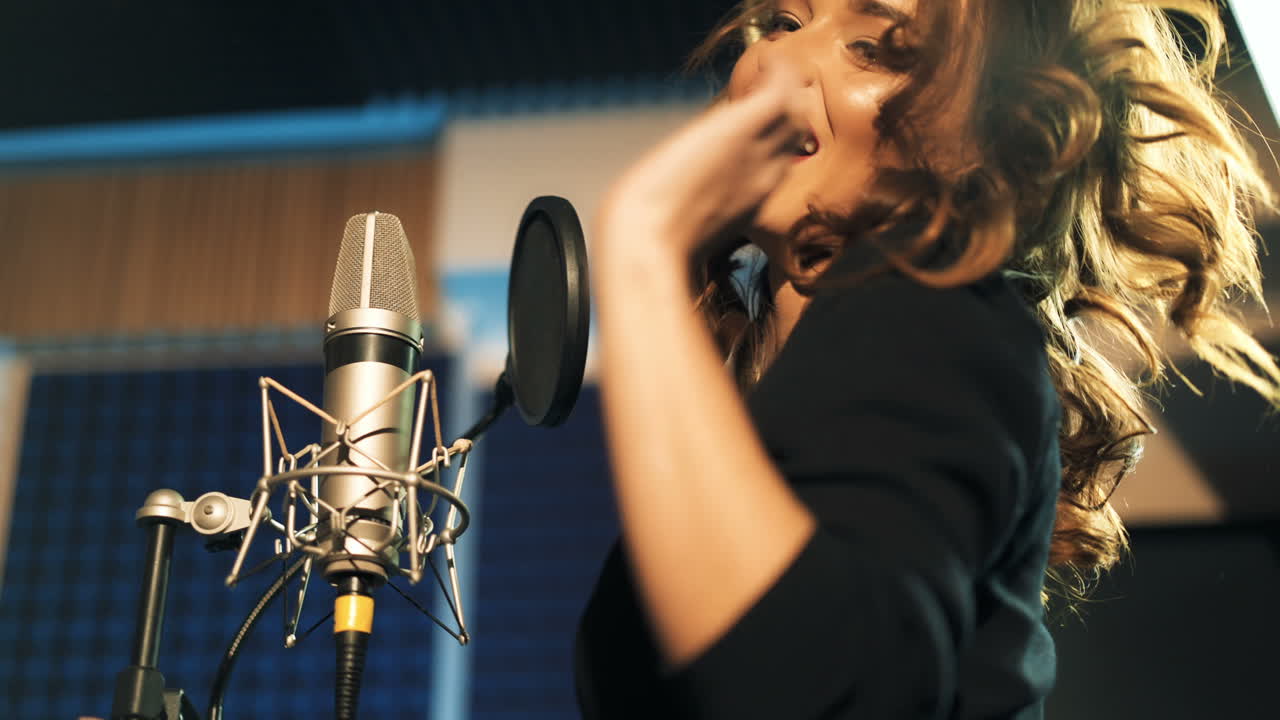 Beautiful young singer who recorded a song in a professional recording studio. Female vocal