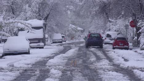 Traffic-moves-down-icy-and-snow-covered-roads-during-a-major-blizzard