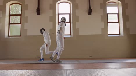 Fencer-athletes-during-a-fencing-training-in-a-gym