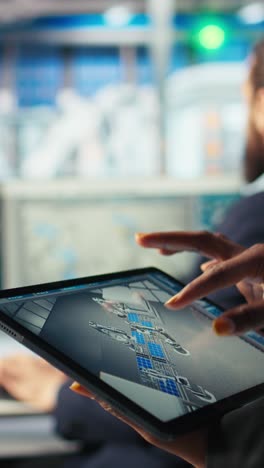 vertical video solar panels plant employee uses cad software on tablet to optimize layouts