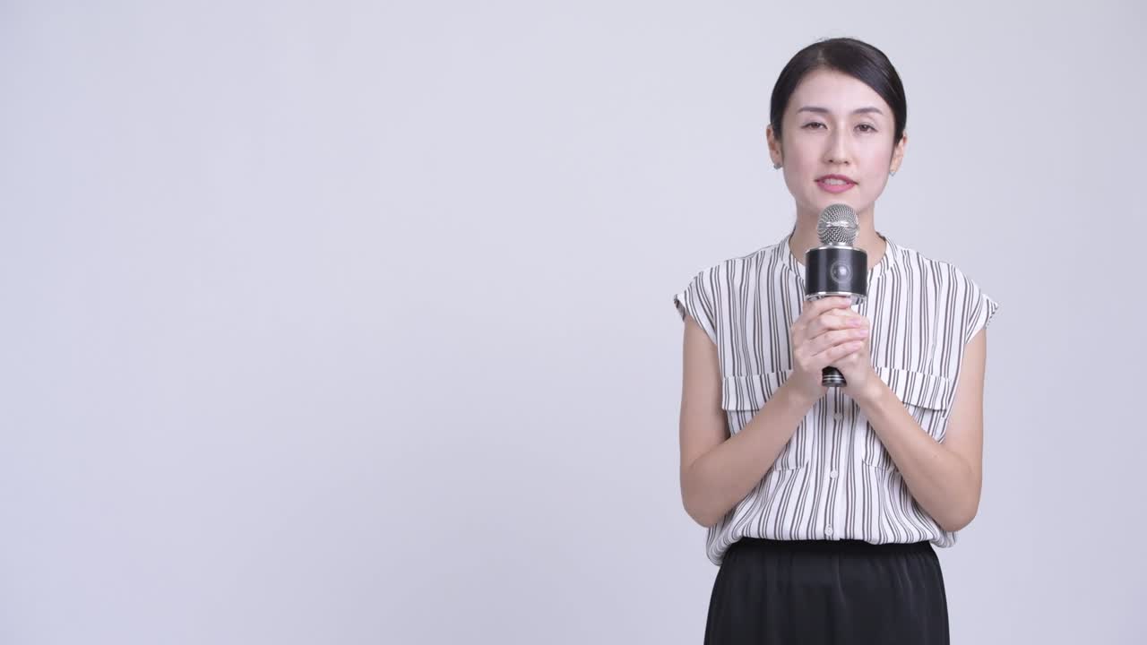 Happy beautiful Asian businesswoman as newscaster