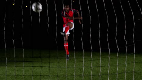 soccer player scoring a goal against open goal post 4k