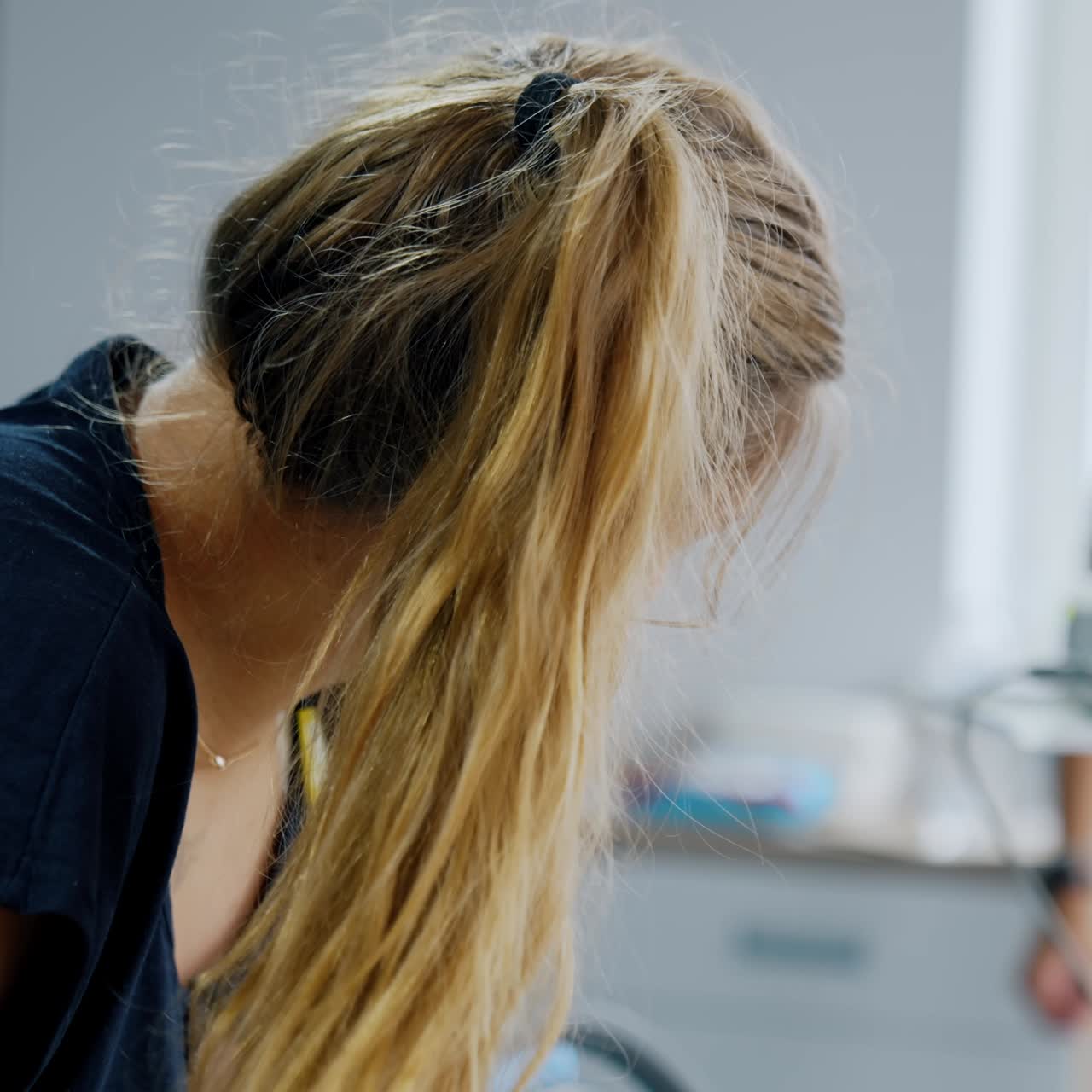 Caucasian long-haired woman stands bending her head ahead. Pregnant lady delivering a baby in clinics