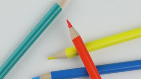 overhead shot of colored pencils isolated on white - close up