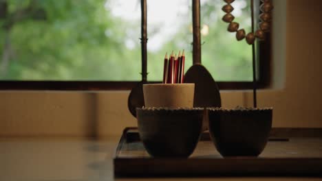 a female hand picking out a pencil from an elegantly styled writing desk