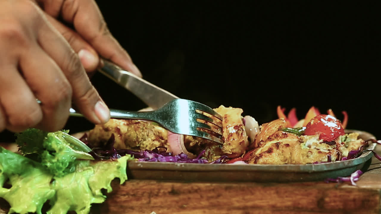 Close-Up Roasted Chicken BBQ With Male Hand Knife Cutting Black Background