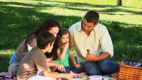 Happy-family-feasting-at-a-picnic-on-a-tablecloth