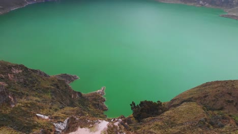 A-massive-lagoon-surrounded-by-mountains-lies-below-with-green-and-blue-water-in-Ecuador-National-Park