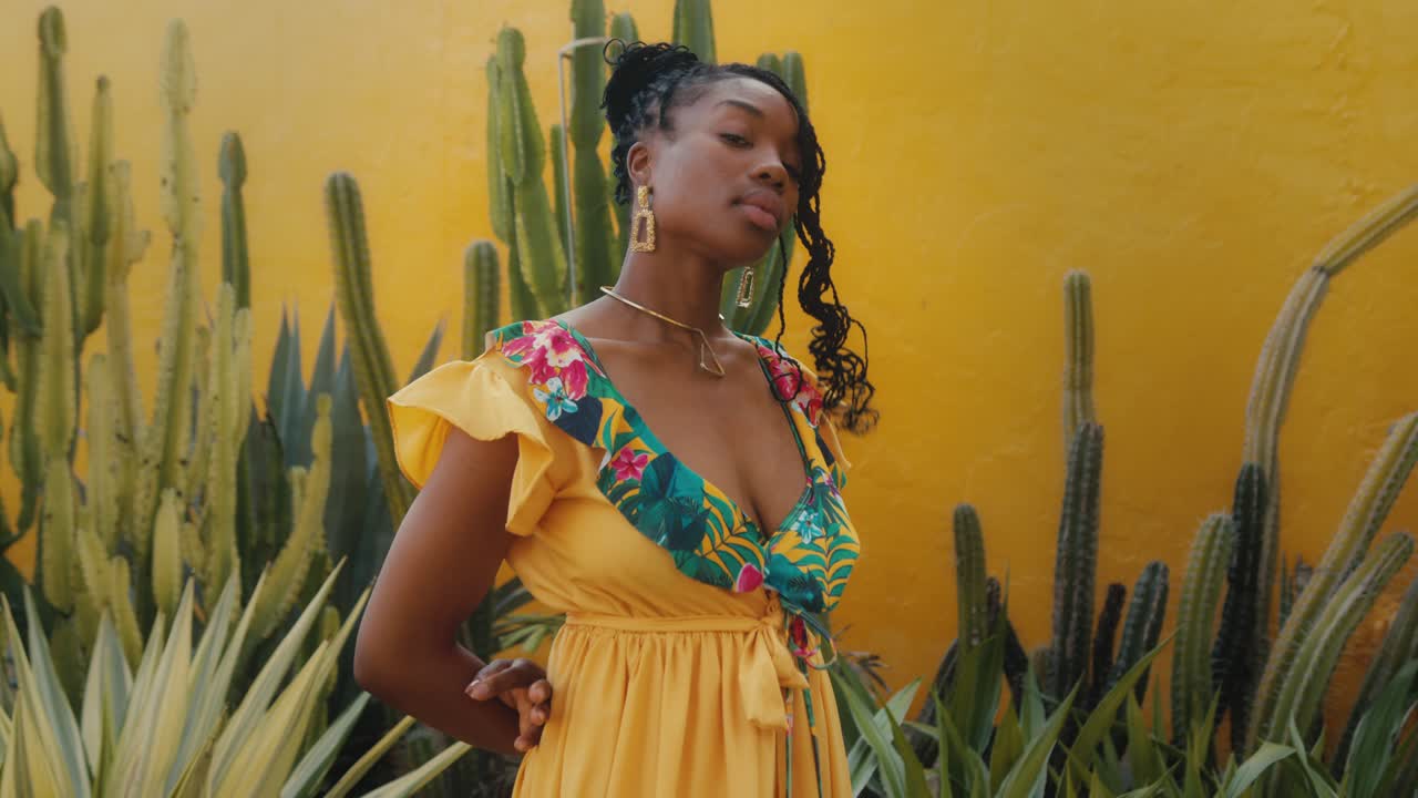 Stylish Woman in a Yellow Floral Dress Amongst Cacti
