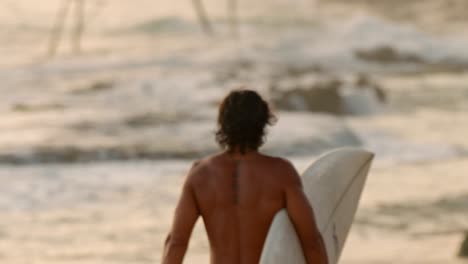 surfer at sunset on weligama beach, sri lanka.
