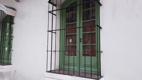 close up view of green colonial windows in old historic building white house presidential area of buenos aires argentina
