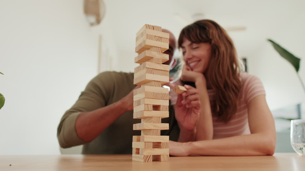 Mixed-race couple Playing Jenga at Home