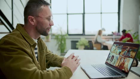man having discussion with business team during web conference