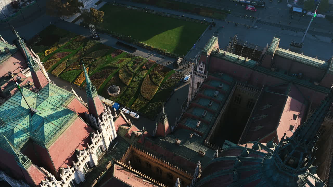 A close aerial of the Parliament’s gothic rooflines and patterned gardens showcasing Budapest’s intricate architectural beauty
